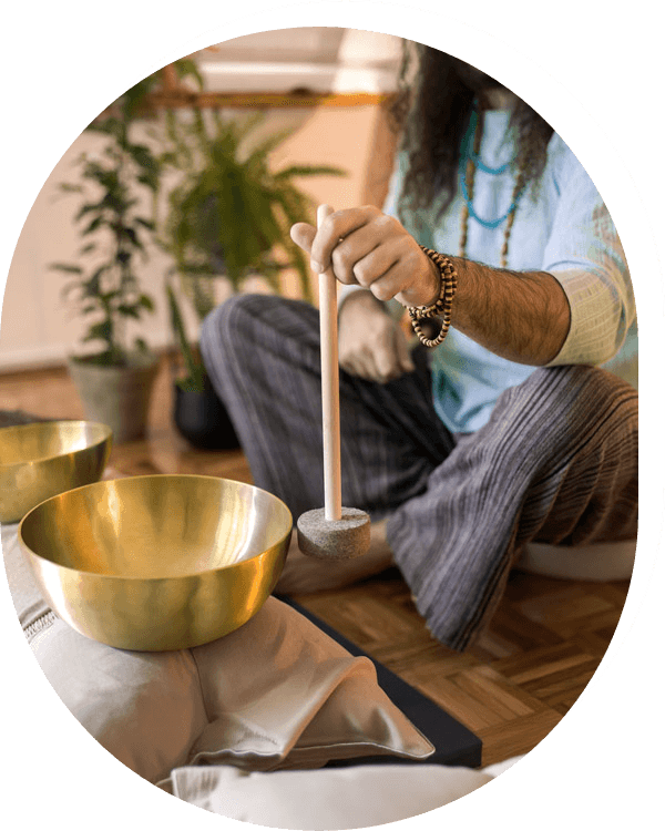 A man sitting on the floor with a bowl of water, engaged in a peaceful moment of reflection and tranquility.