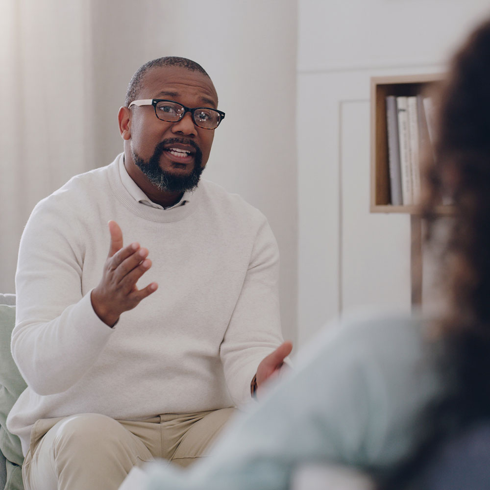 Therapy, support and psychologist talking to a woman about mental health, depression and anxiety