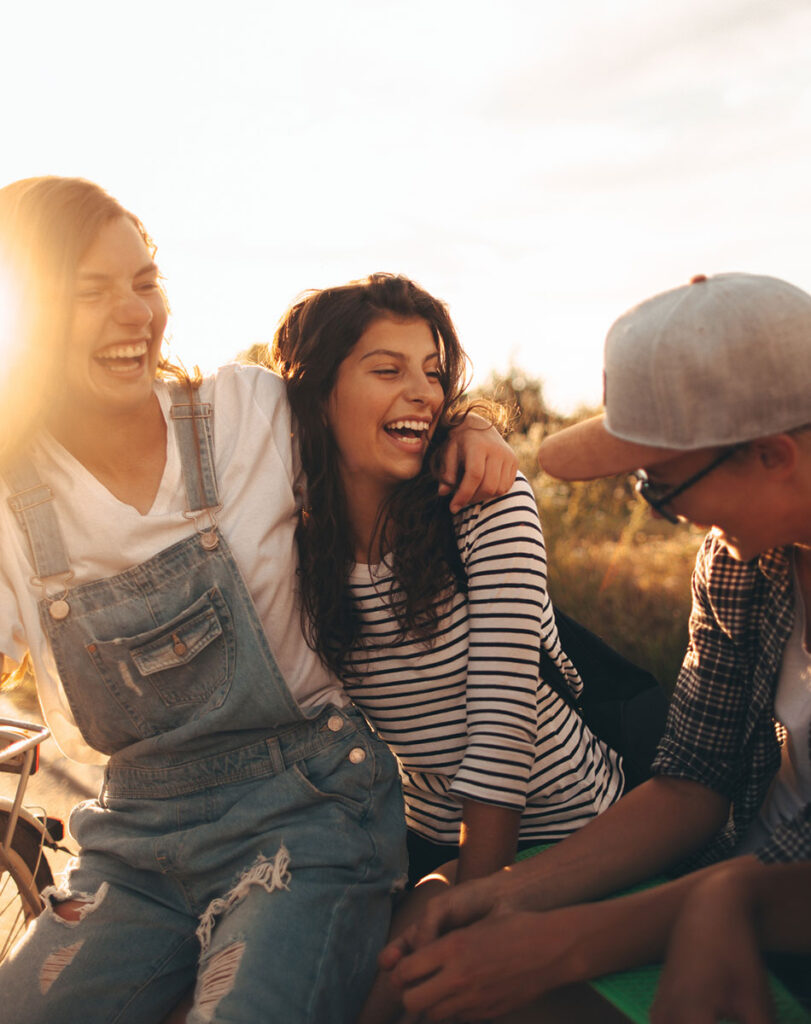 Young people spending time together outside at sunset