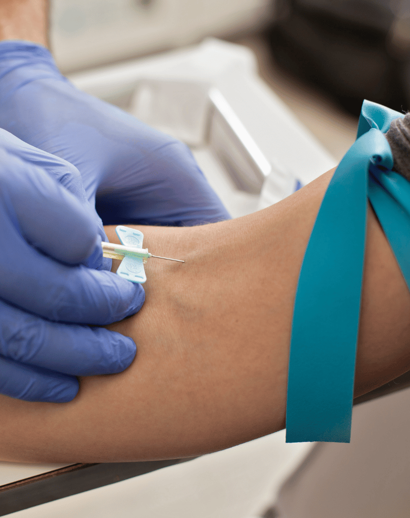 Nurse drawing blood from a patient’s arm