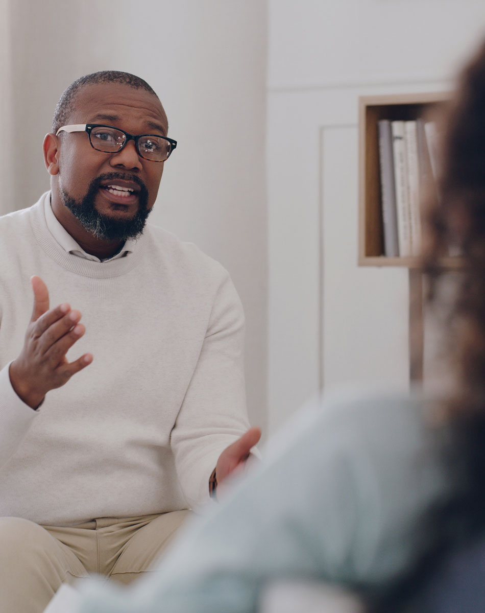 Therapist talking with a client during a CBT session